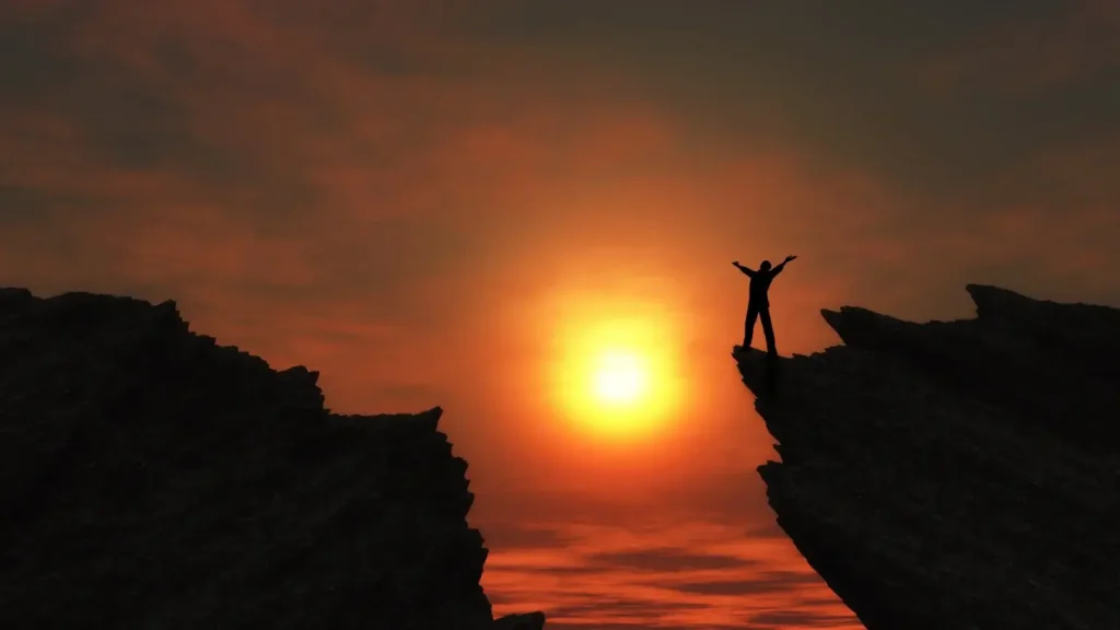 Man standing at the top of a mountain