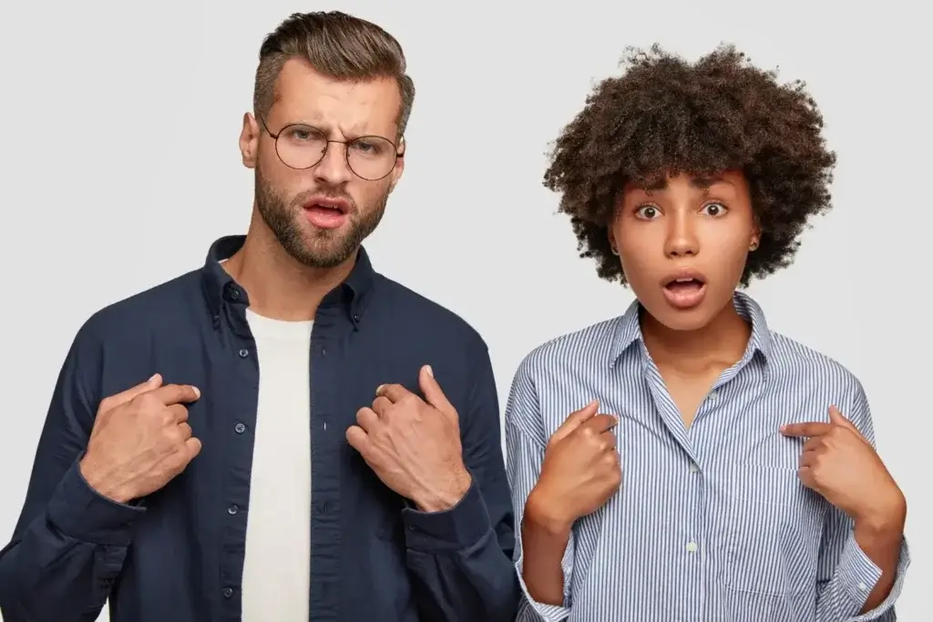 A man and woman making playful faces, symbolizing the lighthearted side of relationships and self-reflection.